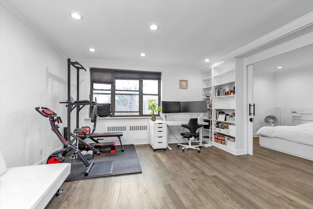 office with wood-type flooring, radiator heating unit, and ornamental molding