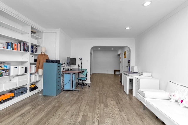 office area featuring light wood-type flooring and ornamental molding