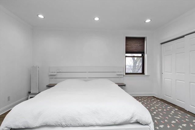 bedroom with a closet and ornamental molding