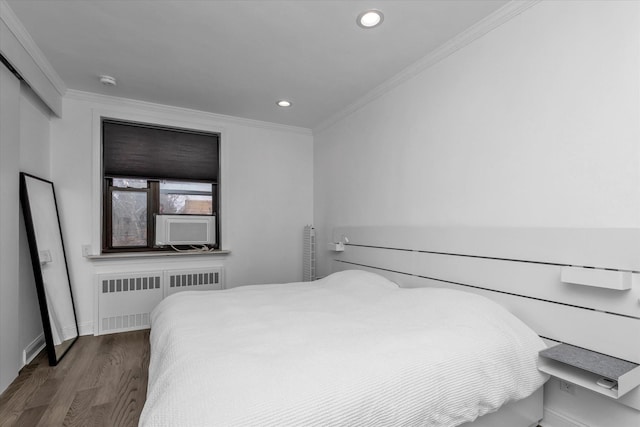 bedroom featuring radiator, dark wood-type flooring, and crown molding