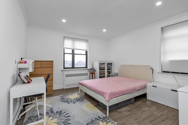 bedroom featuring dark hardwood / wood-style floors, radiator heating unit, and ornamental molding