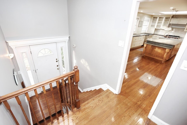 entryway featuring sink and light wood-type flooring