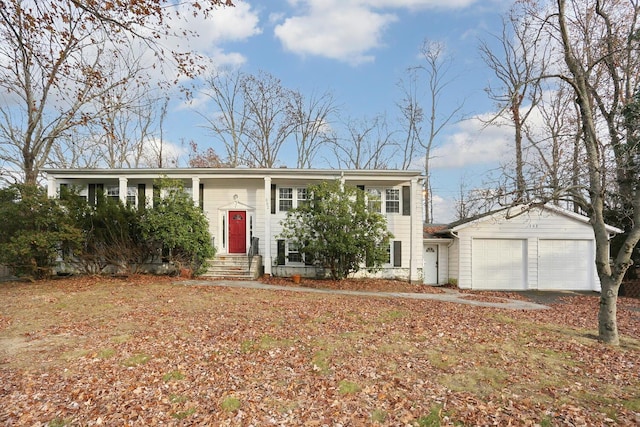 raised ranch with a garage and an outbuilding