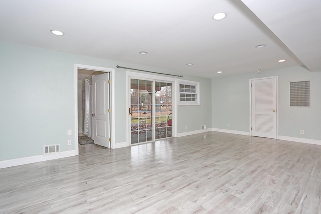 empty room with light hardwood / wood-style flooring