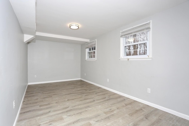 basement with light hardwood / wood-style flooring