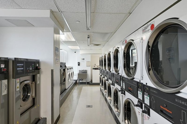 laundry room featuring stacked washer and clothes dryer and washing machine and clothes dryer