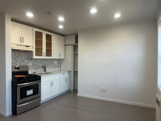 kitchen with sink, stainless steel range with gas cooktop, white cabinetry, backsplash, and dark hardwood / wood-style flooring