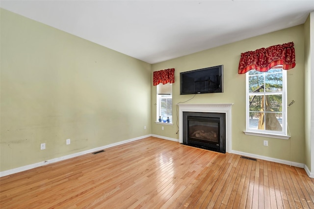 unfurnished living room with hardwood / wood-style flooring