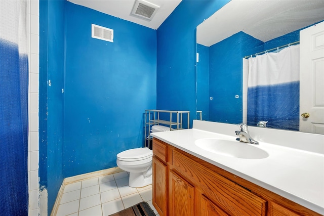 bathroom with walk in shower, vanity, toilet, and tile patterned flooring