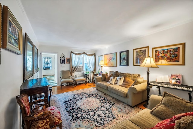 living room featuring crown molding and light hardwood / wood-style floors