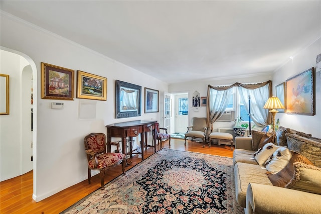 living room featuring wood-type flooring and crown molding