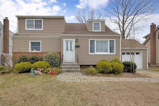 view of front of home with a front yard and a garage