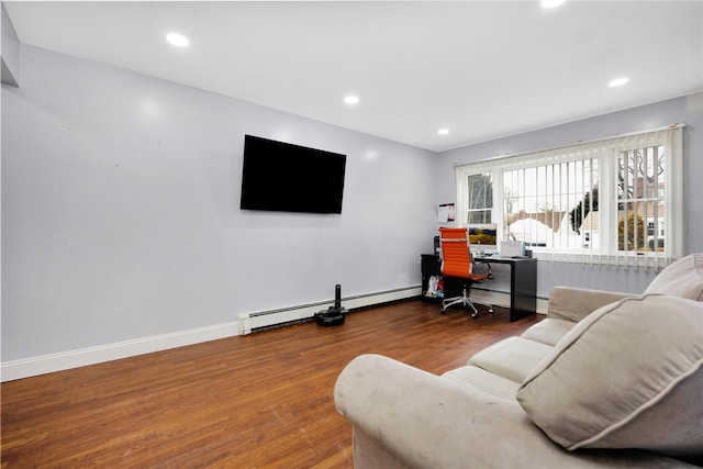 living room with baseboard heating and hardwood / wood-style flooring