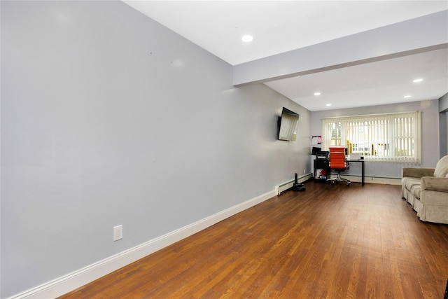 interior space featuring wood-type flooring and a baseboard heating unit