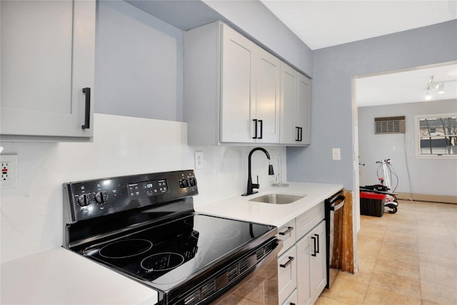 kitchen featuring sink, black / electric stove, white cabinets, and dishwasher