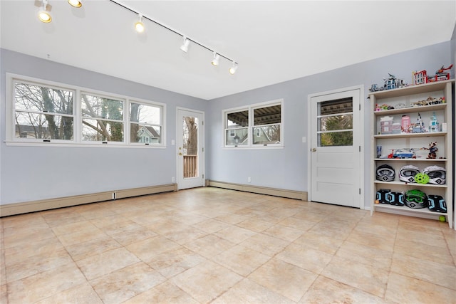 unfurnished room with a baseboard heating unit