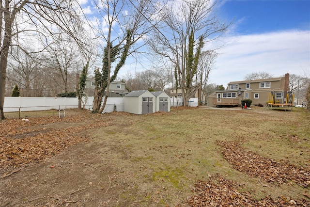 view of yard featuring a trampoline and a storage shed