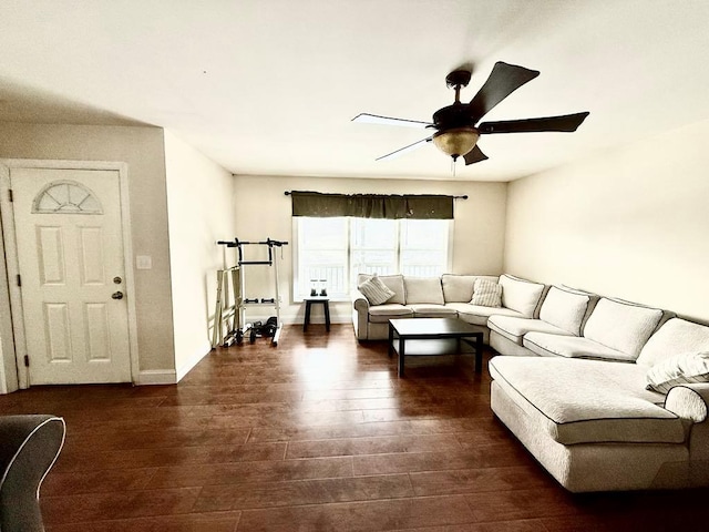 living room featuring ceiling fan and dark hardwood / wood-style flooring