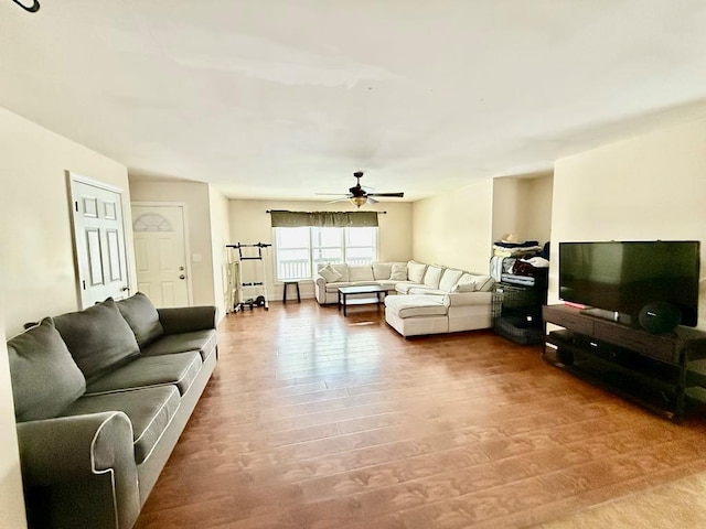 living room with ceiling fan and hardwood / wood-style flooring