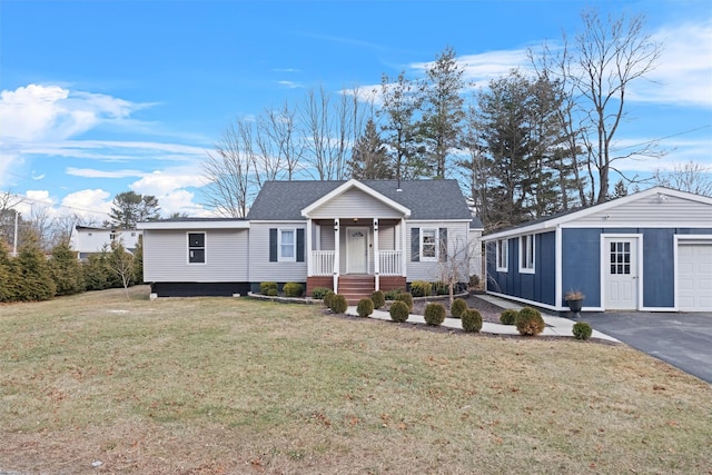 single story home featuring a porch, an outbuilding, and a front lawn