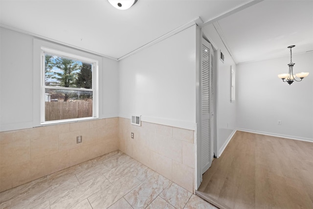 interior space with tile walls and crown molding