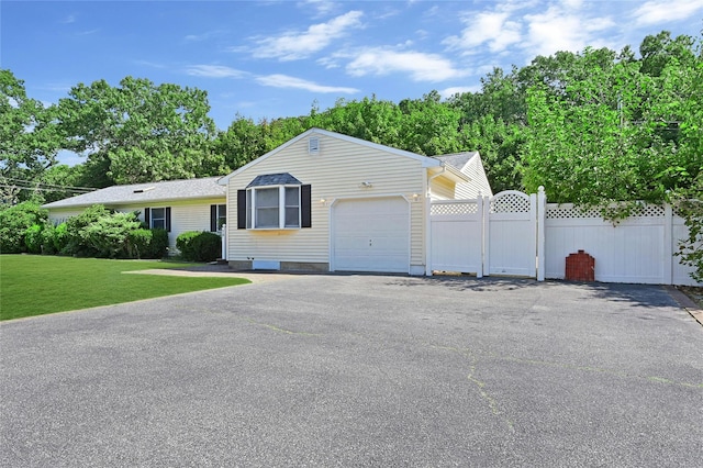 view of front facade with a front yard and a garage