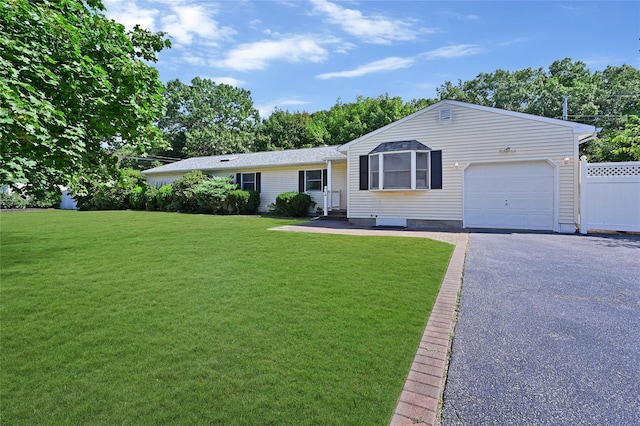 single story home with a garage and a front lawn