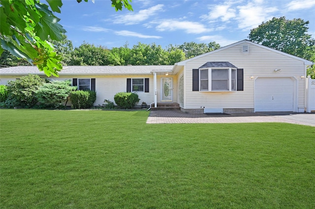 ranch-style house featuring a front yard and a garage