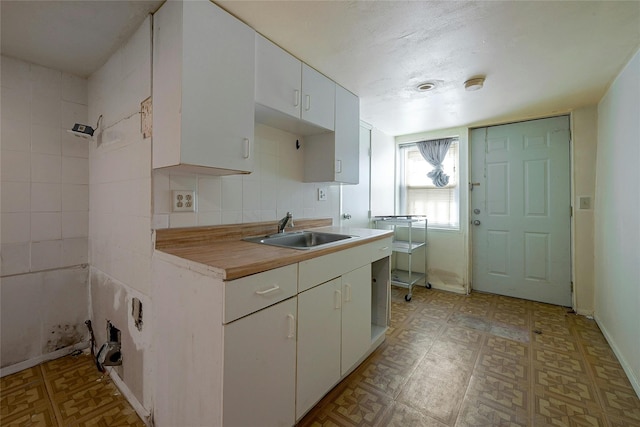 kitchen featuring white cabinets and sink