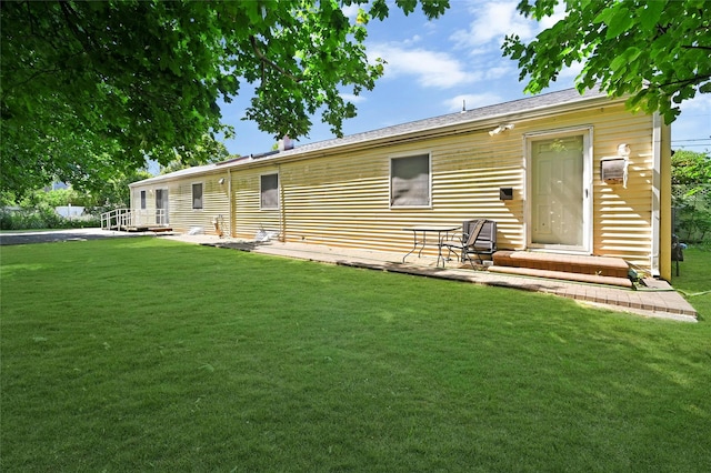 rear view of house featuring a lawn