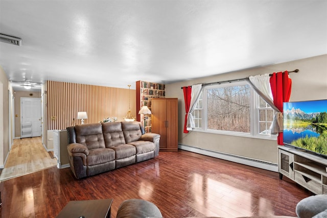 living room with baseboard heating and hardwood / wood-style floors