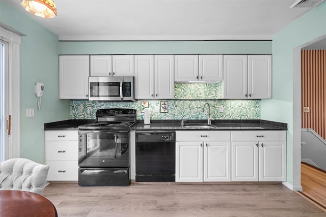 kitchen featuring black appliances, sink, white cabinetry, and light hardwood / wood-style flooring