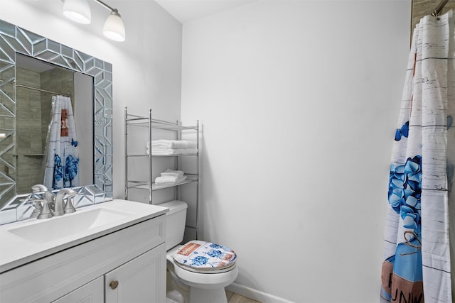 bathroom with toilet, vanity, and curtained shower