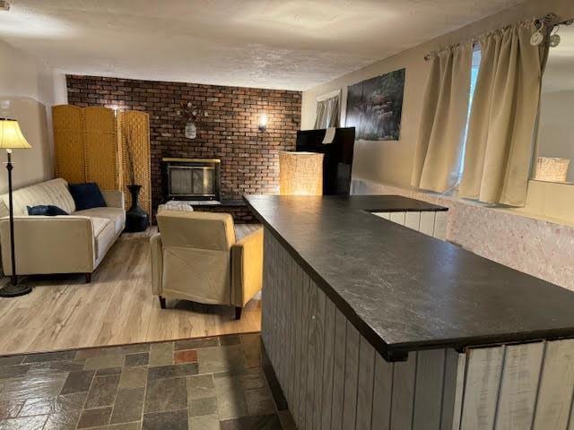 living room featuring a brick fireplace