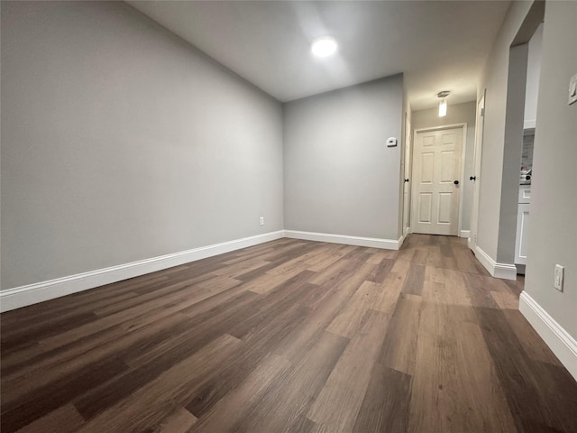 unfurnished room featuring dark wood-type flooring