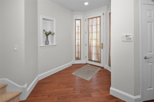 entryway with dark hardwood / wood-style floors