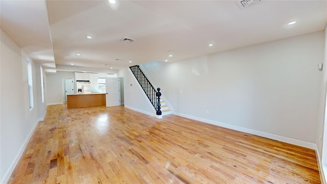 unfurnished living room featuring light hardwood / wood-style flooring