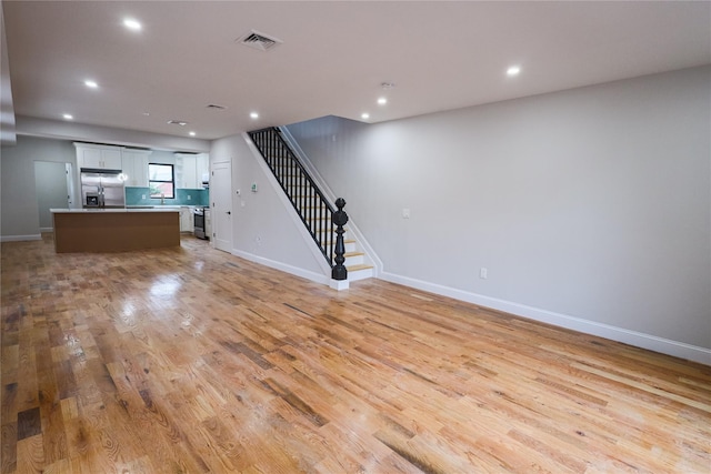 unfurnished living room with light hardwood / wood-style floors