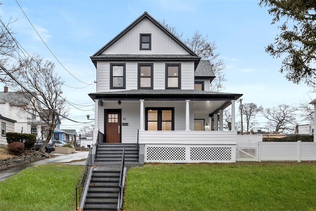 view of front of property featuring covered porch and a front lawn