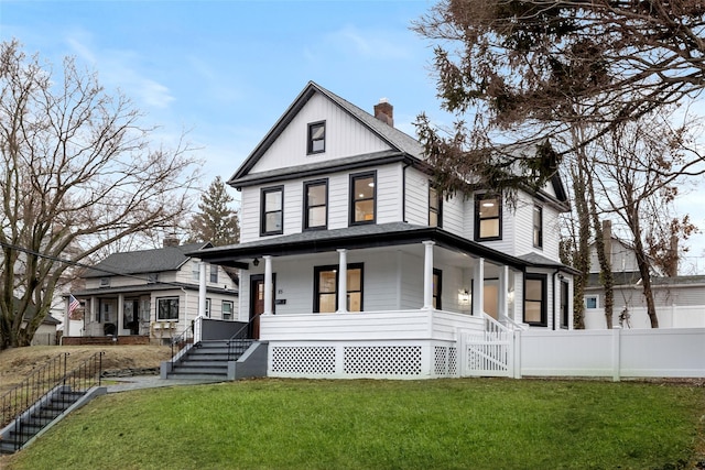 view of front facade with a front lawn and a porch