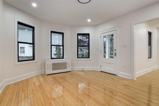 entrance foyer featuring light hardwood / wood-style floors and radiator heating unit