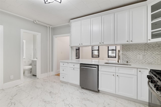 kitchen with stainless steel appliances, white cabinetry, and sink