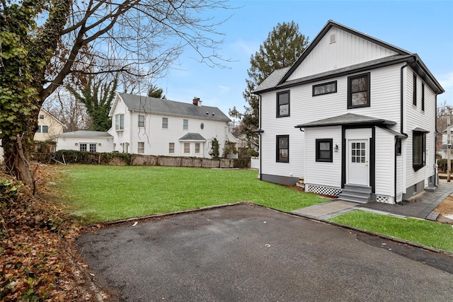 back of house featuring a yard