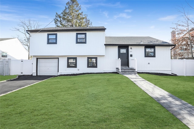 tri-level home with a front yard and a garage