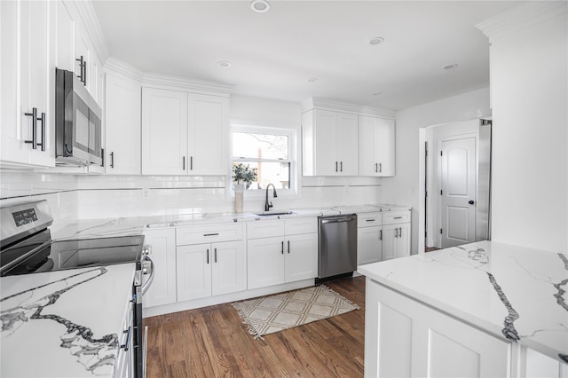 kitchen featuring stainless steel appliances, light stone countertops, dark hardwood / wood-style flooring, white cabinets, and sink