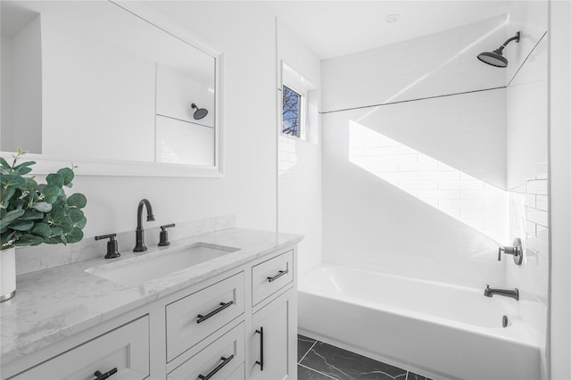 bathroom with vanity and tiled shower / bath