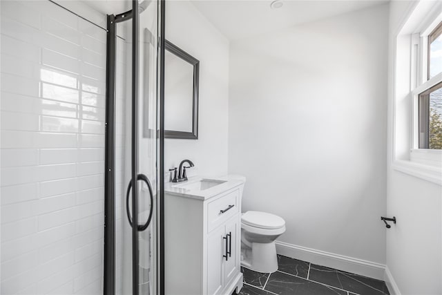 bathroom featuring an enclosed shower, vanity, and toilet