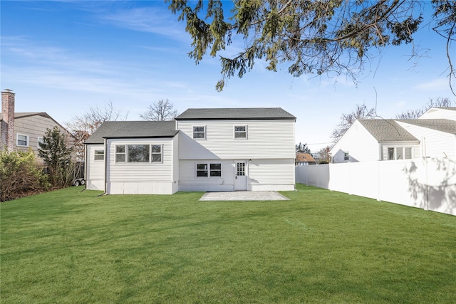 back of property featuring a yard and a patio area