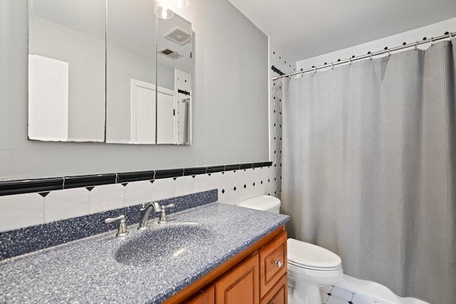 bathroom featuring tasteful backsplash, tile walls, tile patterned flooring, vanity, and toilet