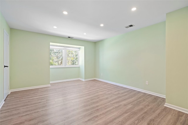 spare room featuring light hardwood / wood-style flooring